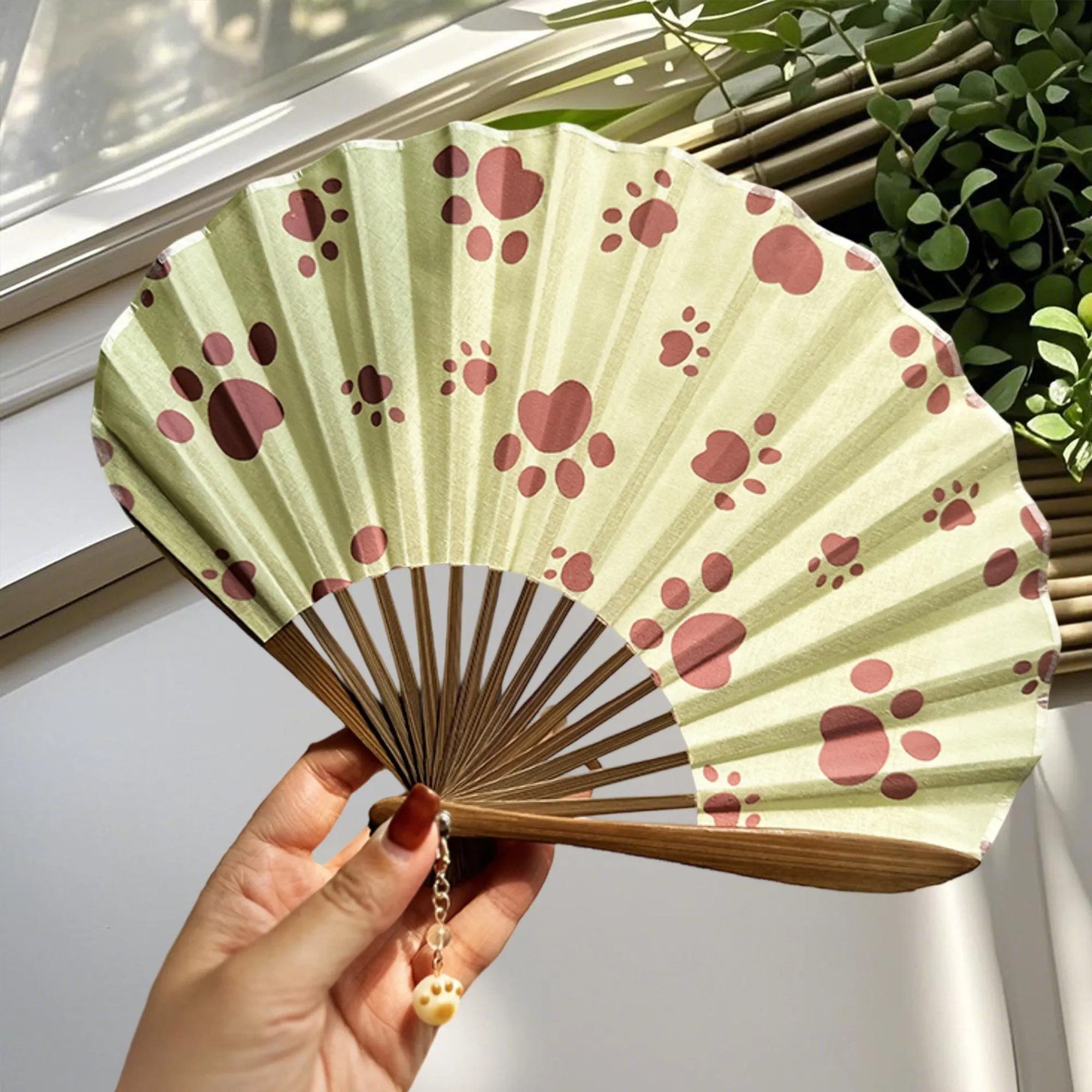 Folding fan with dog paw print pattern