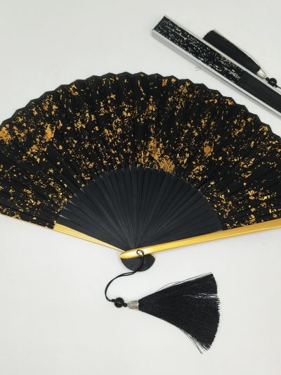 Black folding fan with gold ink splash pattern