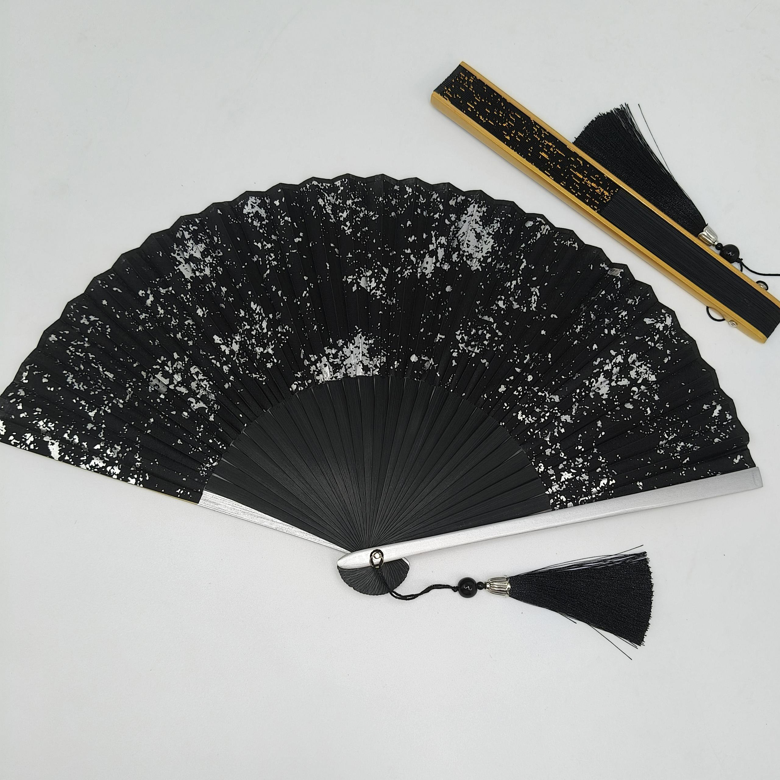 Black folding fan with gold ink splash pattern - Image 2