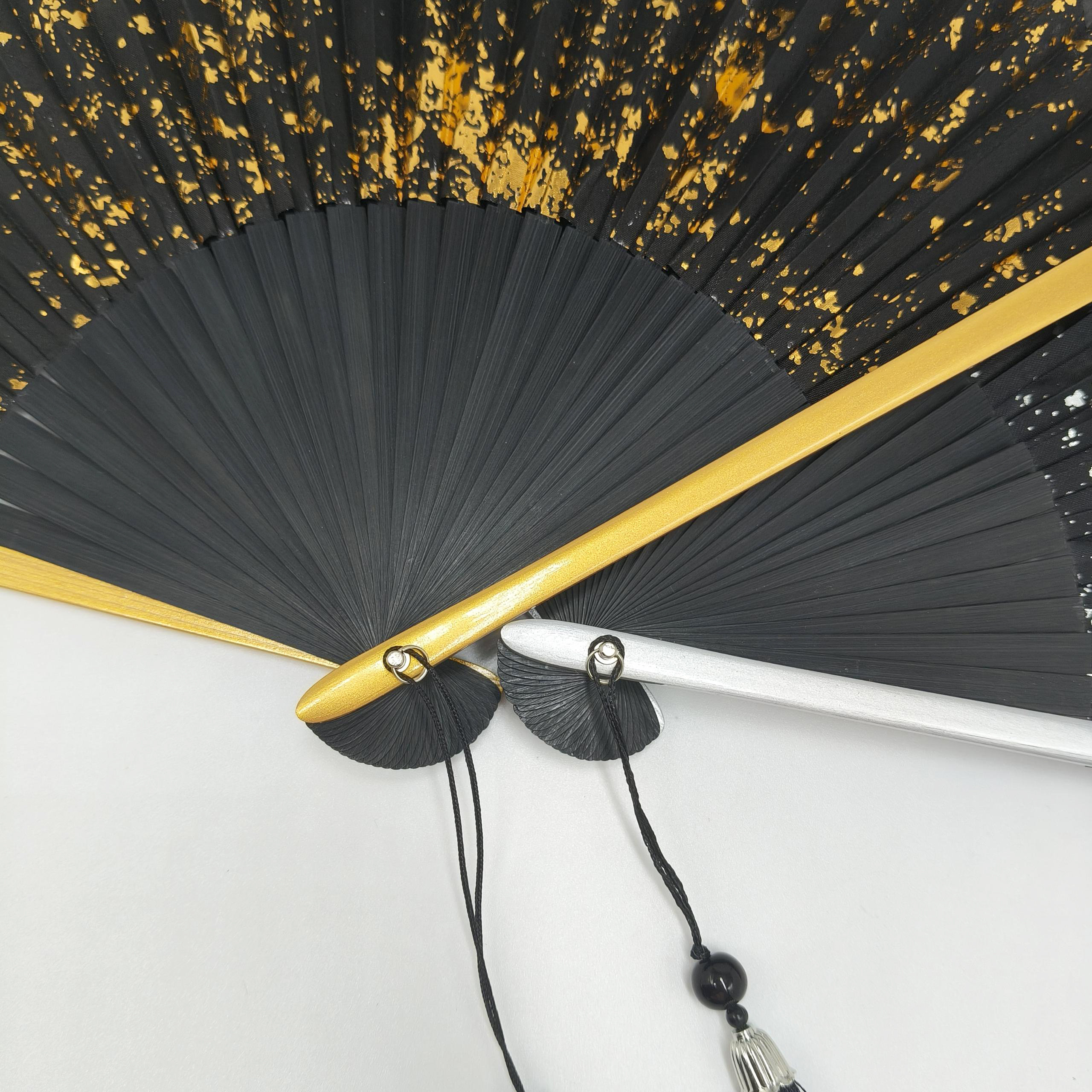 Black folding fan with gold ink splash pattern - Image 4