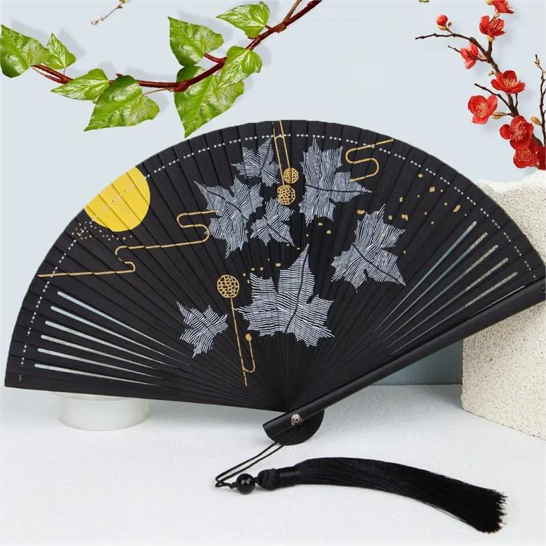 Folding fan with silver maple leaf and gold moon pattern - Image 3