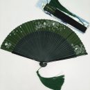 White floral tassels, dark green folding fan